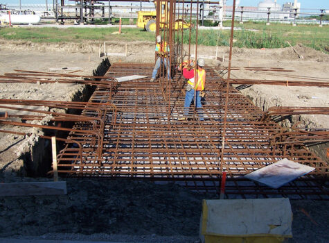 Workers setting rebar for foundation