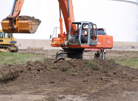 Excavator stripping topsoil