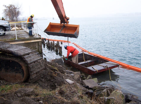 Man in barge working on the waters edge