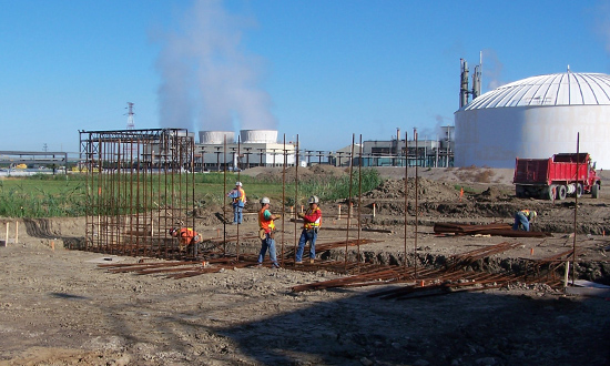 Workers setting up concrete foundations